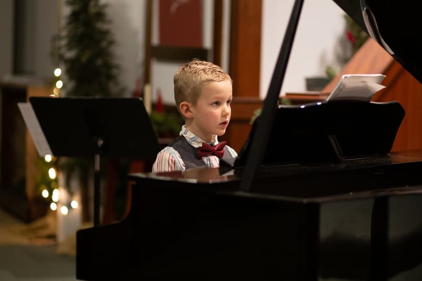 a young boy at a piano recital